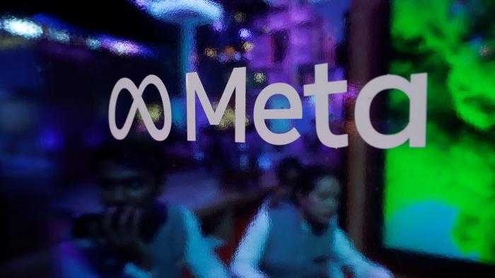People are seen behind a logo of Meta Platforms, during a conference in Mumbai, India, September 20, 2023. REUTERS/Francis Mascarenhas/File Photo